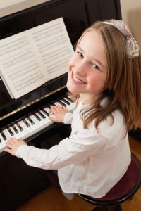 girl practising piano